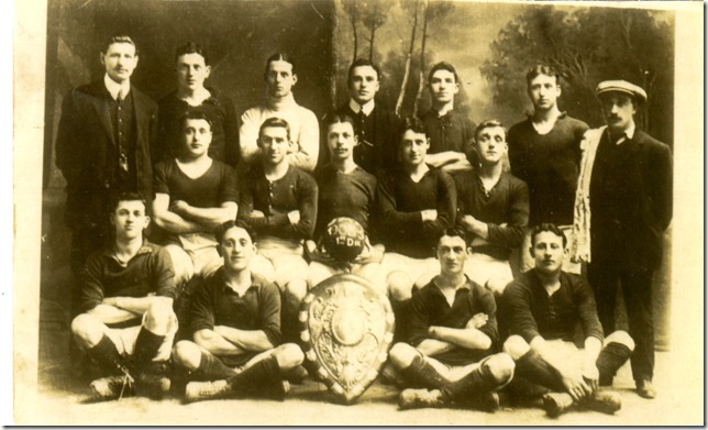 Lubel is seated to the left of the shield