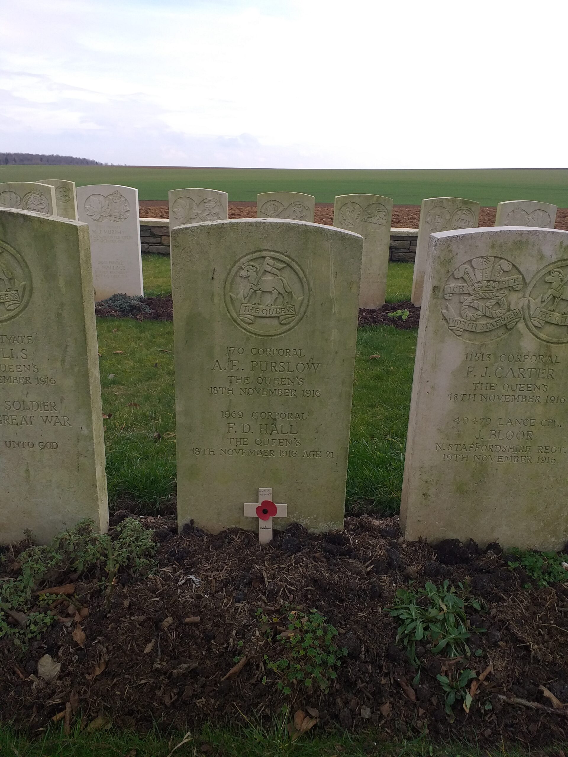 World War One graves at Stump Road, showing Commonwealth War Graves Commission headstone for A E Purslow, with a small commemorative cross in front